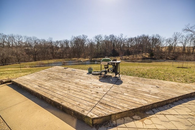 wooden terrace with a lawn