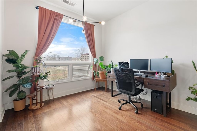 home office featuring visible vents, baseboards, and wood-type flooring