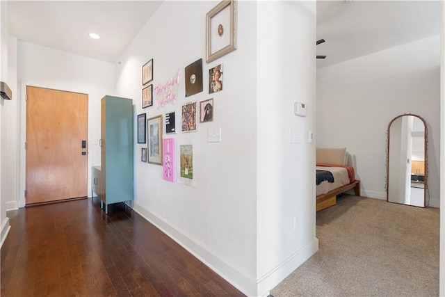 hall featuring recessed lighting, baseboards, and wood finished floors