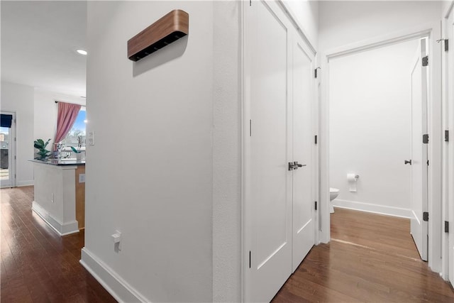 hall with recessed lighting, baseboards, and wood finished floors