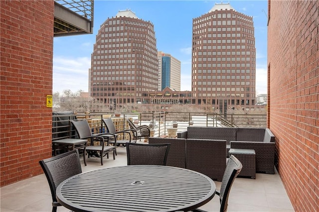 view of patio / terrace with a city view and an outdoor living space