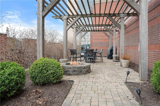 view of patio featuring a pergola and an outdoor fire pit