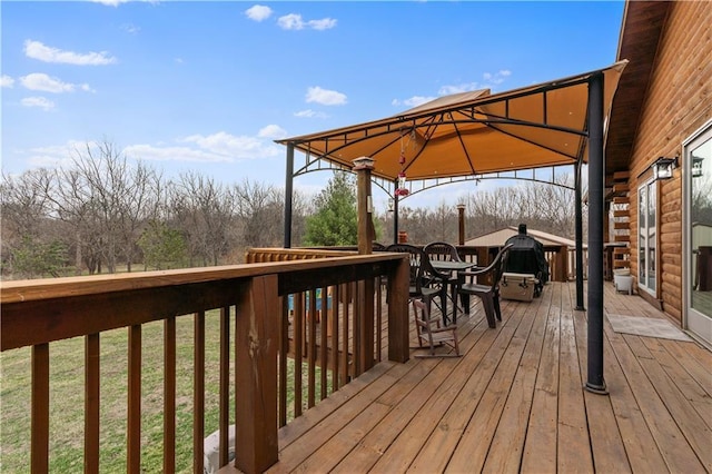 deck featuring a gazebo and outdoor dining area