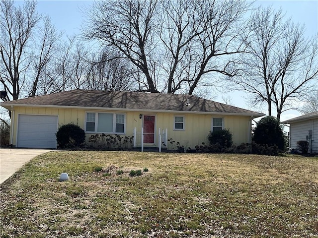 ranch-style home with a garage, a front yard, board and batten siding, and driveway