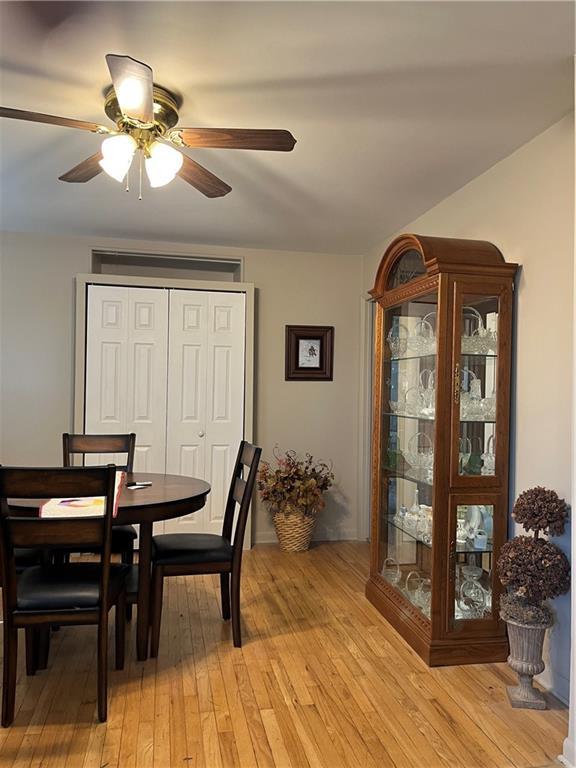 dining space featuring light wood-type flooring and ceiling fan