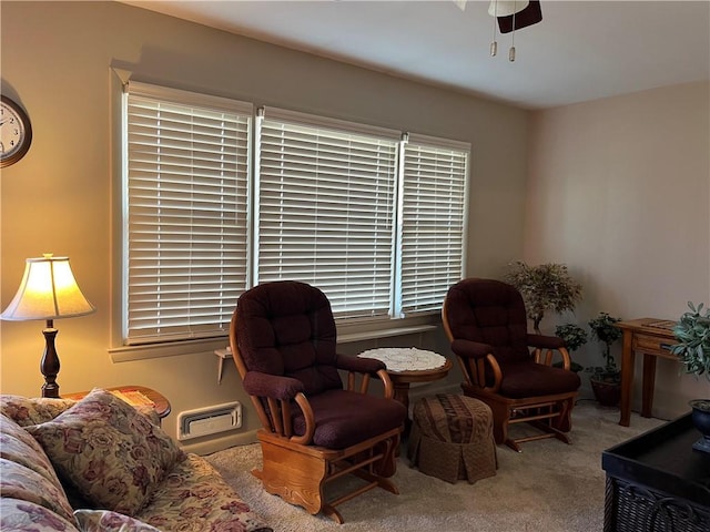 sitting room featuring carpet flooring and a ceiling fan