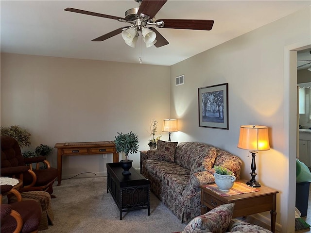 carpeted living room with visible vents and ceiling fan