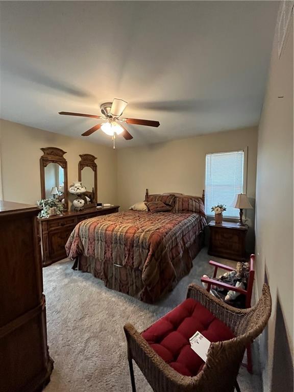 carpeted bedroom featuring ceiling fan