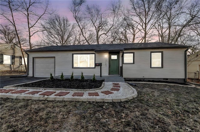 ranch-style house with aphalt driveway and an attached garage