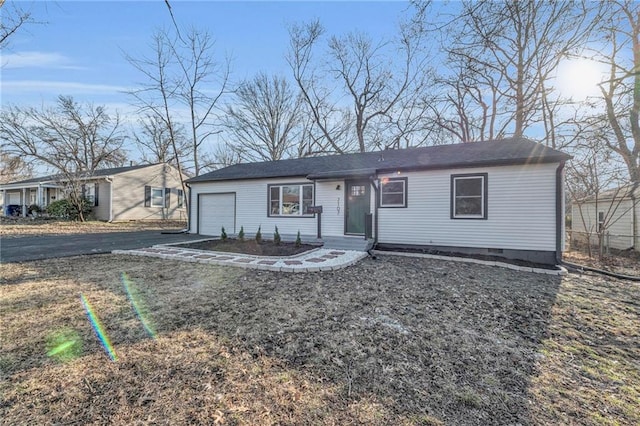 ranch-style home featuring aphalt driveway, crawl space, and a garage