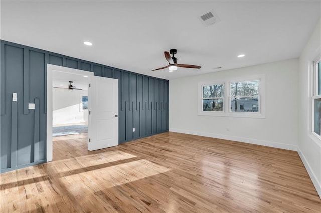 unfurnished room with visible vents, ceiling fan, and light wood-style flooring