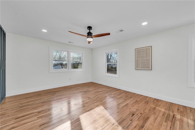 unfurnished room with visible vents, baseboards, and light wood-style floors