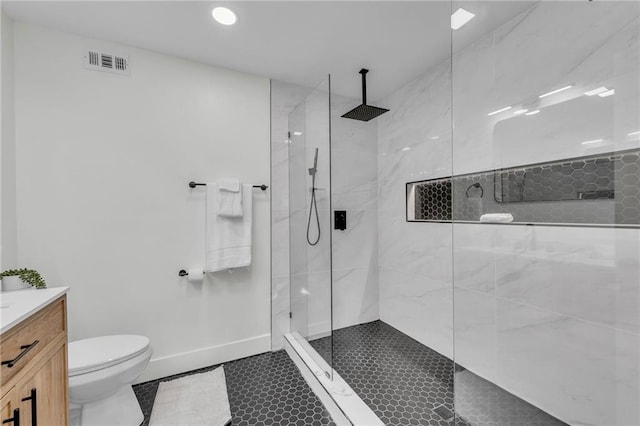 full bath featuring vanity, visible vents, baseboards, a walk in shower, and toilet