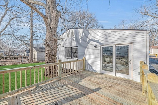 wooden terrace featuring a yard