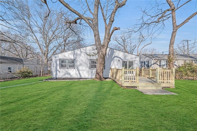 back of house with a wooden deck and a yard