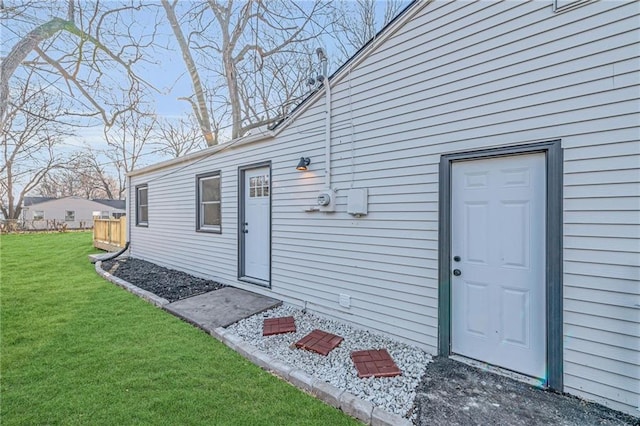 entrance to property with a lawn