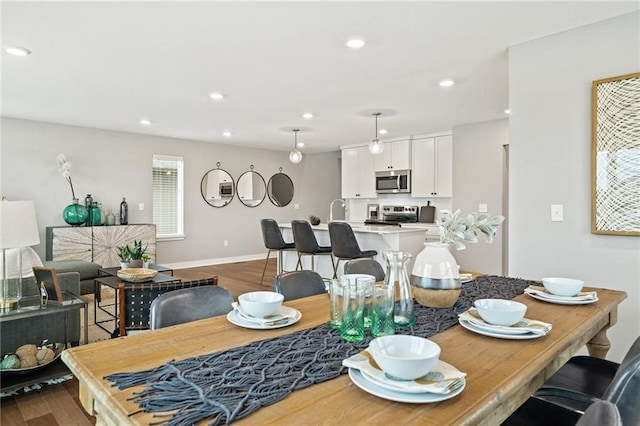 dining room featuring recessed lighting, baseboards, and wood finished floors