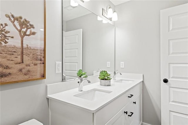 bathroom featuring a sink and double vanity