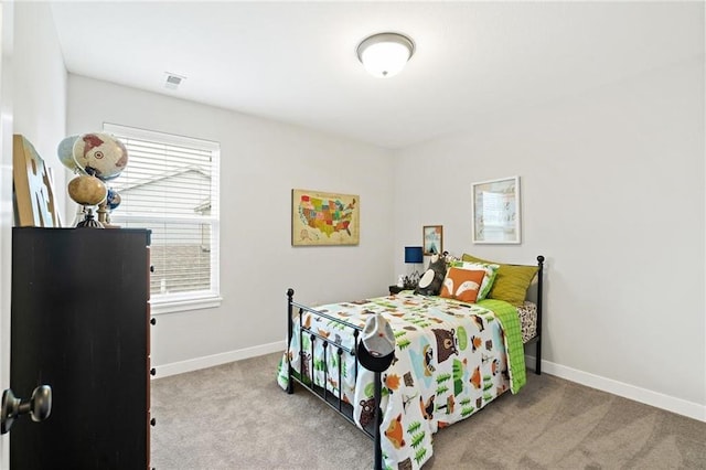 carpeted bedroom featuring visible vents and baseboards