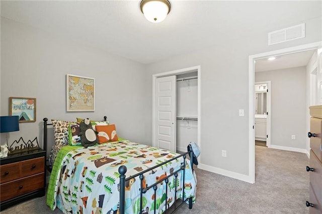 carpeted bedroom with visible vents, baseboards, and a closet