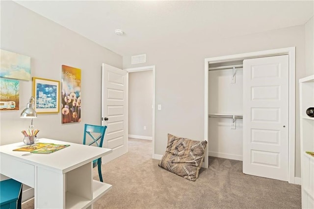 office area with carpet flooring, baseboards, and visible vents