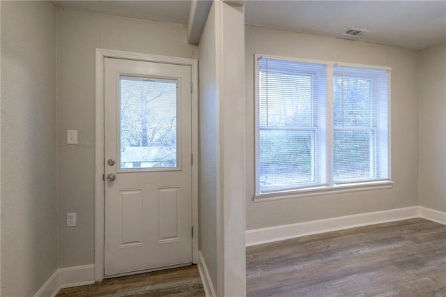 entryway featuring visible vents, baseboards, and dark wood-type flooring