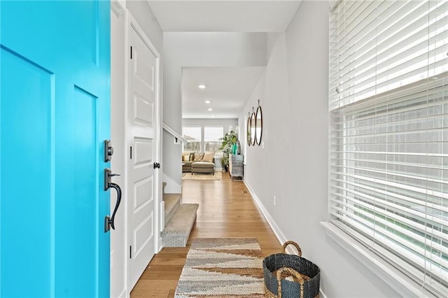 foyer with recessed lighting, light wood-type flooring, and baseboards