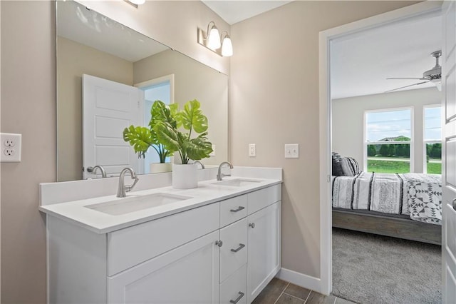 bathroom featuring ensuite bath, a ceiling fan, double vanity, and a sink