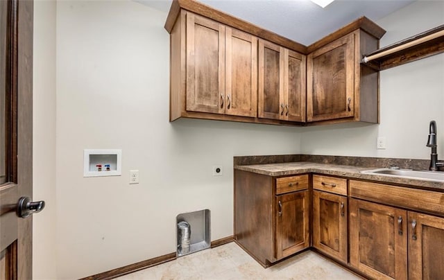 laundry room featuring a sink, cabinet space, baseboards, hookup for an electric dryer, and hookup for a washing machine