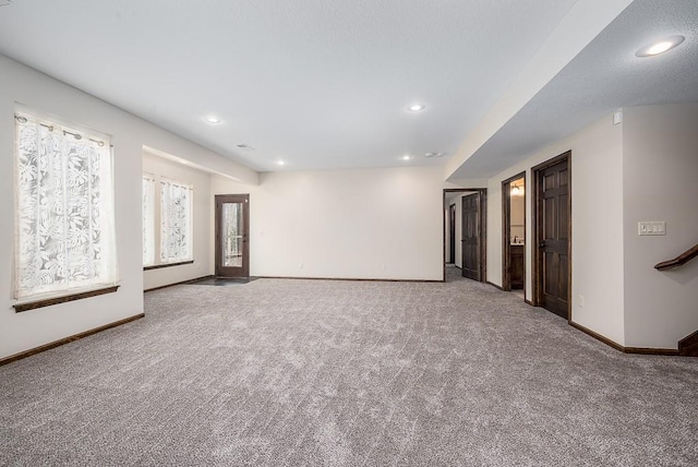 empty room featuring carpet flooring, recessed lighting, and baseboards