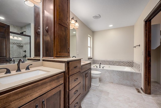 full bathroom featuring vanity, visible vents, a shower stall, a textured ceiling, and a bath