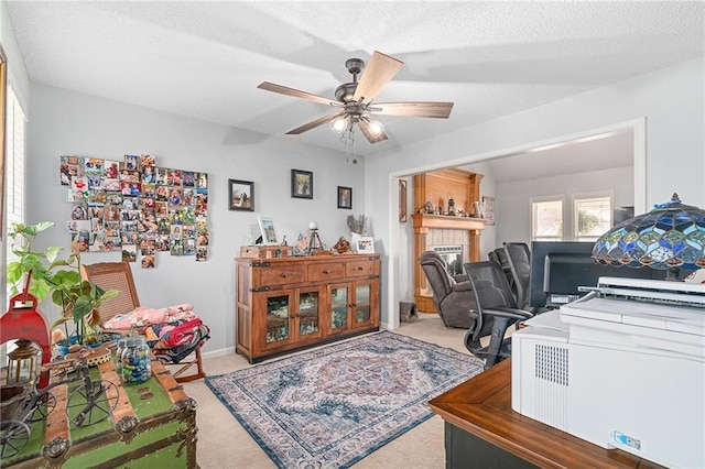 office area featuring a ceiling fan, carpet, baseboards, and a textured ceiling