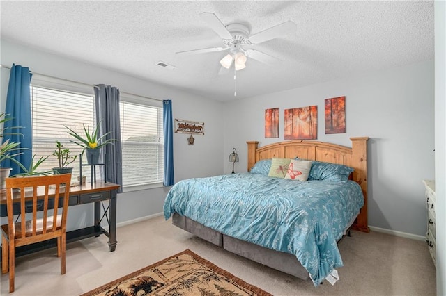 carpeted bedroom with visible vents, baseboards, and a textured ceiling