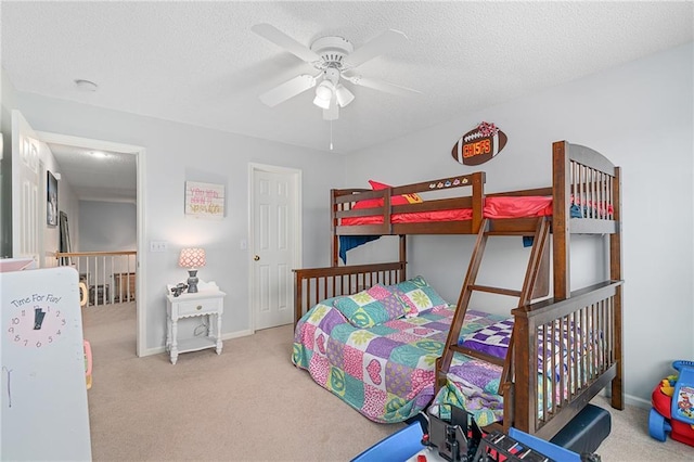 bedroom with carpet flooring, a ceiling fan, baseboards, and a textured ceiling