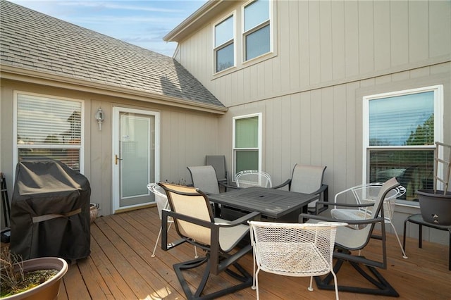 wooden deck featuring grilling area and outdoor dining area