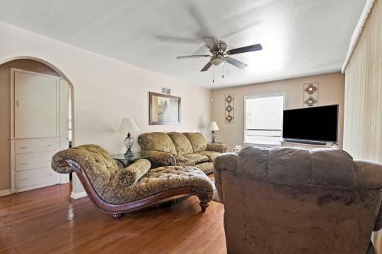 6745 Cleveland Ave, Kansas City, MO 64132 - living room featuring a ceiling fan, arched walkways, and wood finished floors