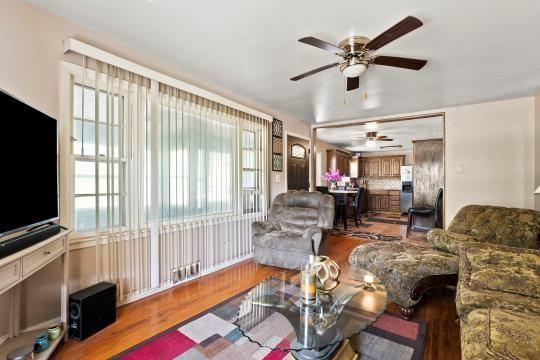 6745 Cleveland Ave, Kansas City, MO 64132 - living area featuring a ceiling fan and wood finished floors