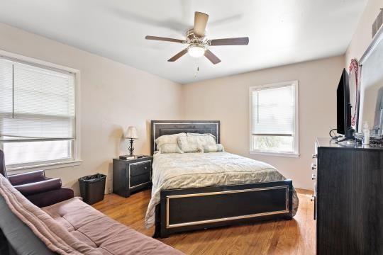 6745 Cleveland Ave, Kansas City, MO 64132 - bedroom with a ceiling fan, visible vents, and wood finished floors