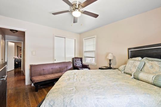 6745 Cleveland Ave, Kansas City, MO 64132 - bedroom with a ceiling fan, a closet, and dark wood-style flooring