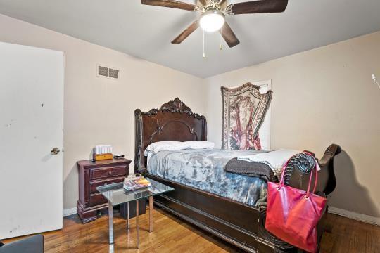 6745 Cleveland Ave, Kansas City, MO 64132 - bedroom with ceiling fan, baseboards, visible vents, and wood finished floors