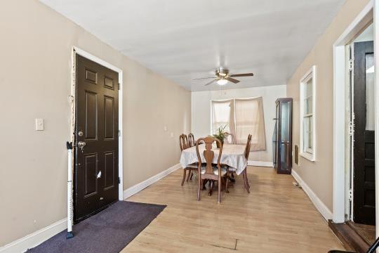 6745 Cleveland Ave, Kansas City, MO 64132 - dining space with a ceiling fan, baseboards, and light wood finished floors