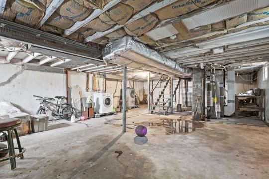 6745 Cleveland Ave, Kansas City, MO 64132 - unfinished basement featuring separate washer and dryer, stairway, and water heater