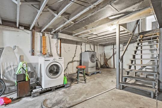 6745 Cleveland Ave, Kansas City, MO 64132 - unfinished below grade area with washer / clothes dryer