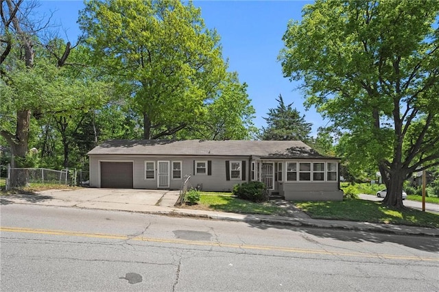 6745 Cleveland Ave, Kansas City, MO 64132 - ranch-style home featuring a garage, fence, and driveway