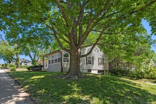 6745 Cleveland Ave, Kansas City, MO 64132 - view of home's exterior with a lawn