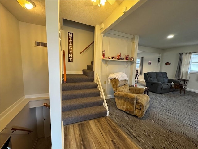 interior space with wood finished floors, visible vents, and baseboards