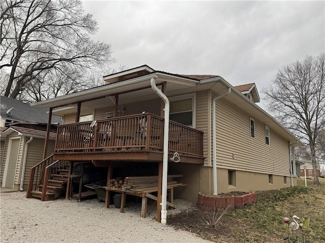 view of home's exterior featuring stairway and a wooden deck