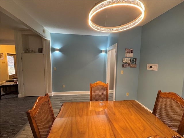 dining area featuring wood finished floors and baseboards