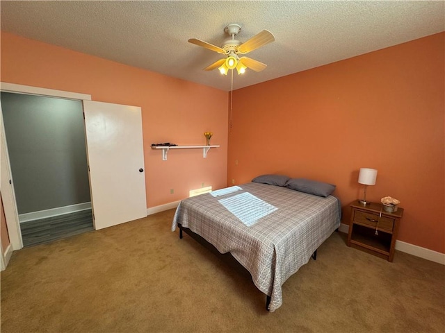 bedroom with baseboards, carpet, a ceiling fan, and a textured ceiling