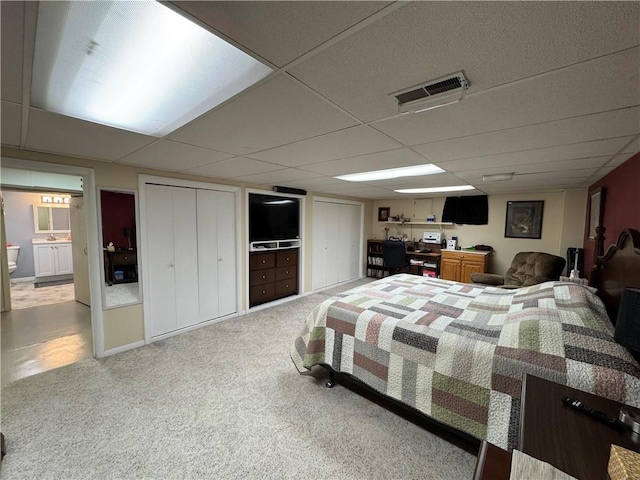 carpeted bedroom featuring visible vents and a paneled ceiling